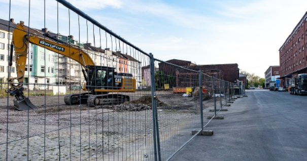 Temporary metal fence pieces in construction zone for future residential area