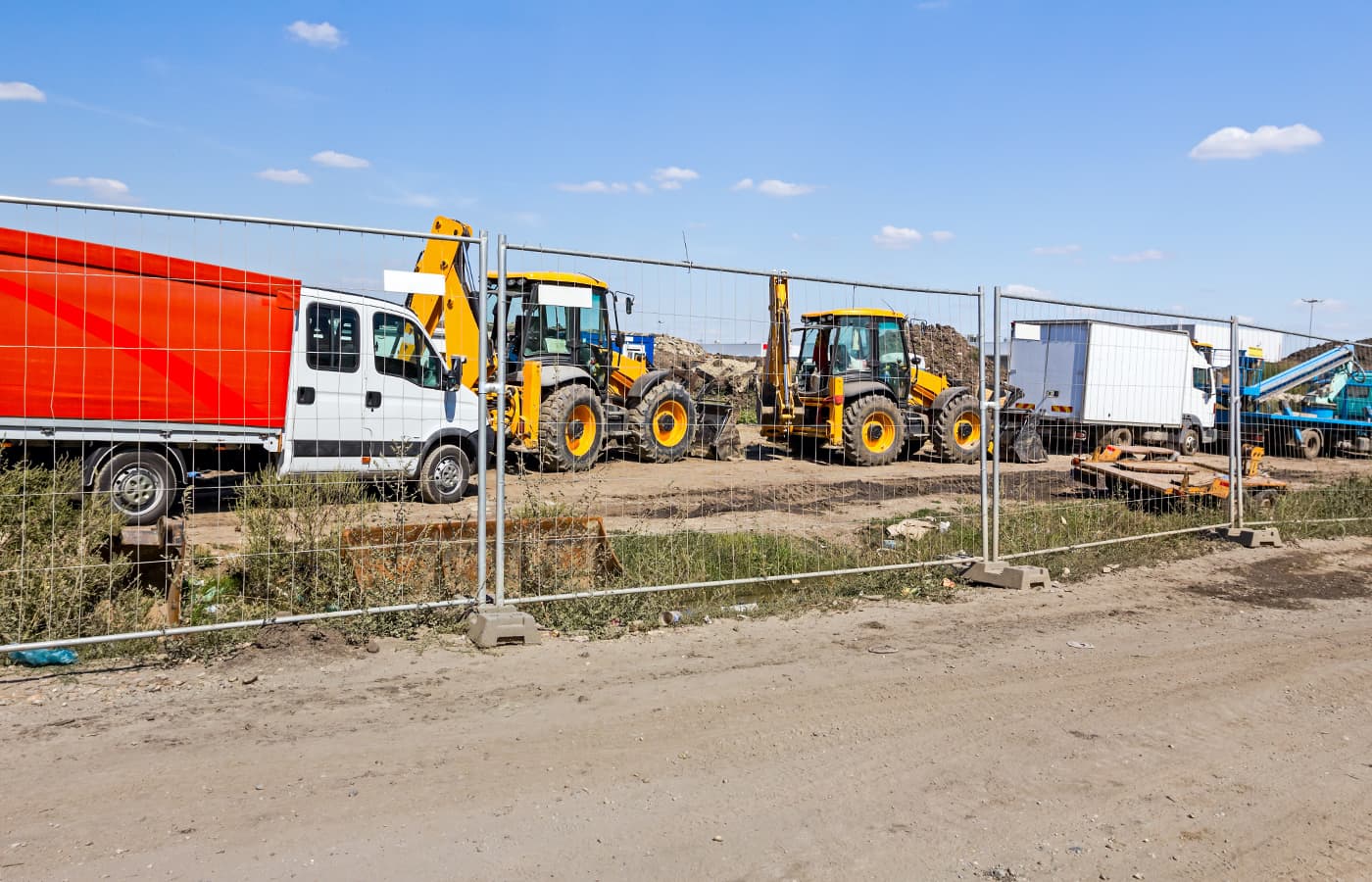 Temporary metal construction fence units along a street outside a construction site